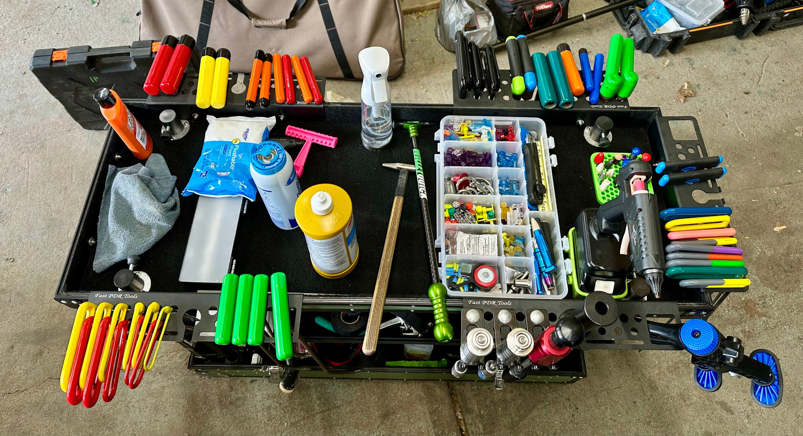 Professional PDR tool cart with rods, tap-down tools, glue tabs and specialty equipment organized for paintless dent repair